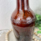 Vintage Amber Bottle with Rose Details with Greenery